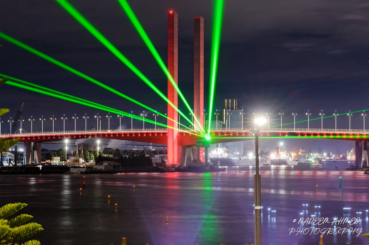 Melbourne bridge lit by green laser beams at night, photographed with the Nikon Z9 and NIKKOR Z 135mm f/1.8 S Plena
